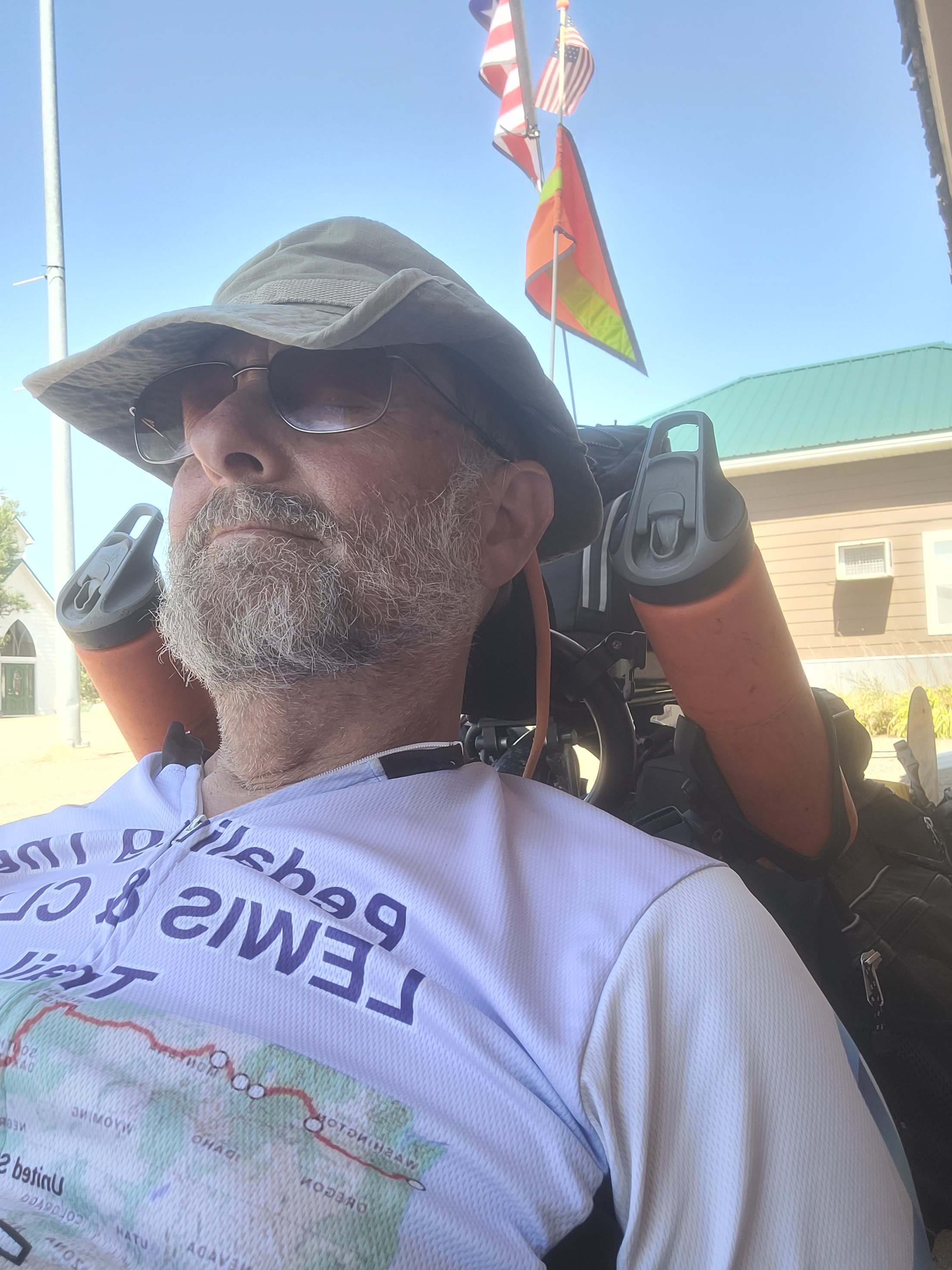 Man with binoculars wearing hat outdoors