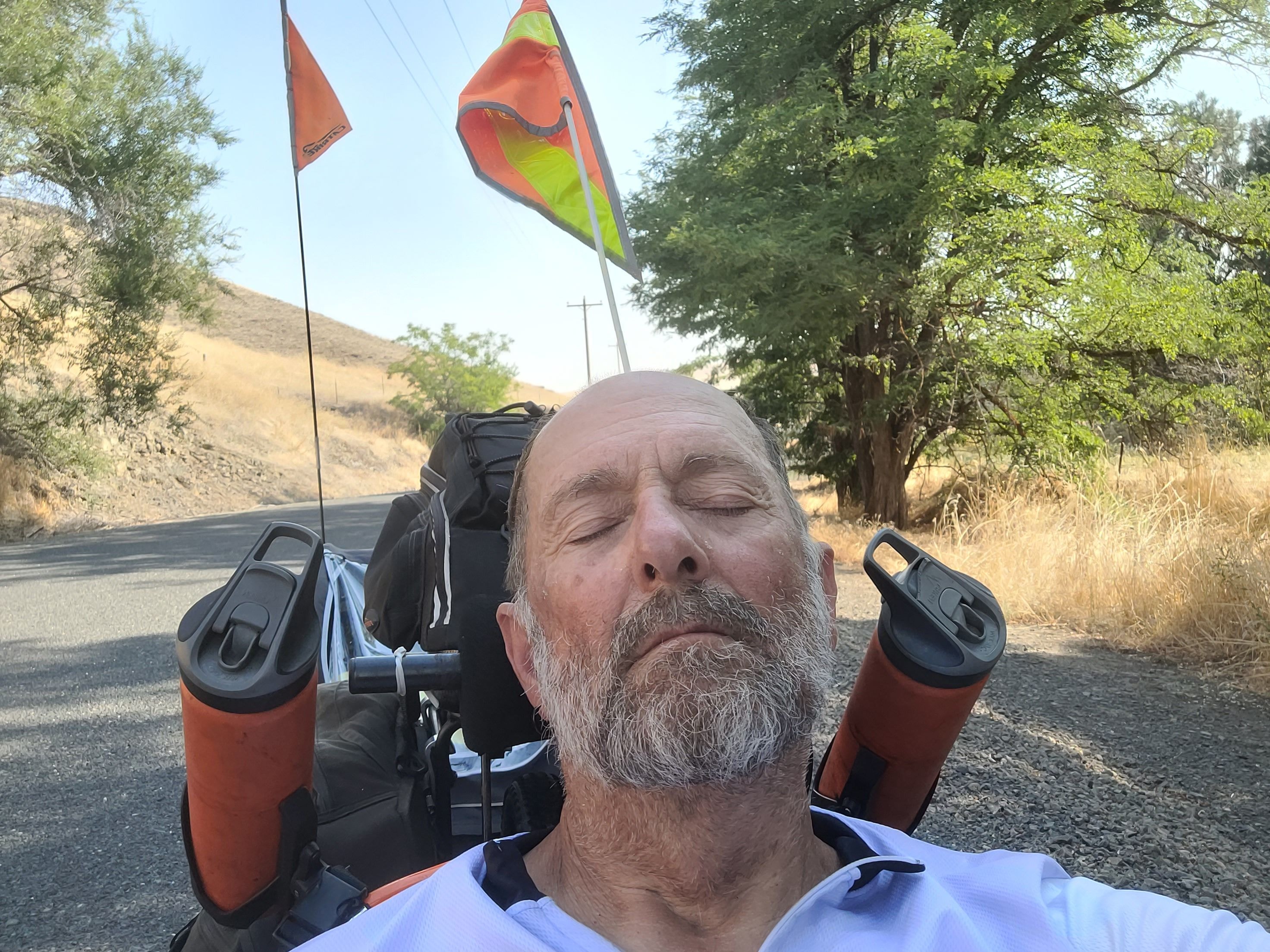 Man with recumbent trike and kite outdoors