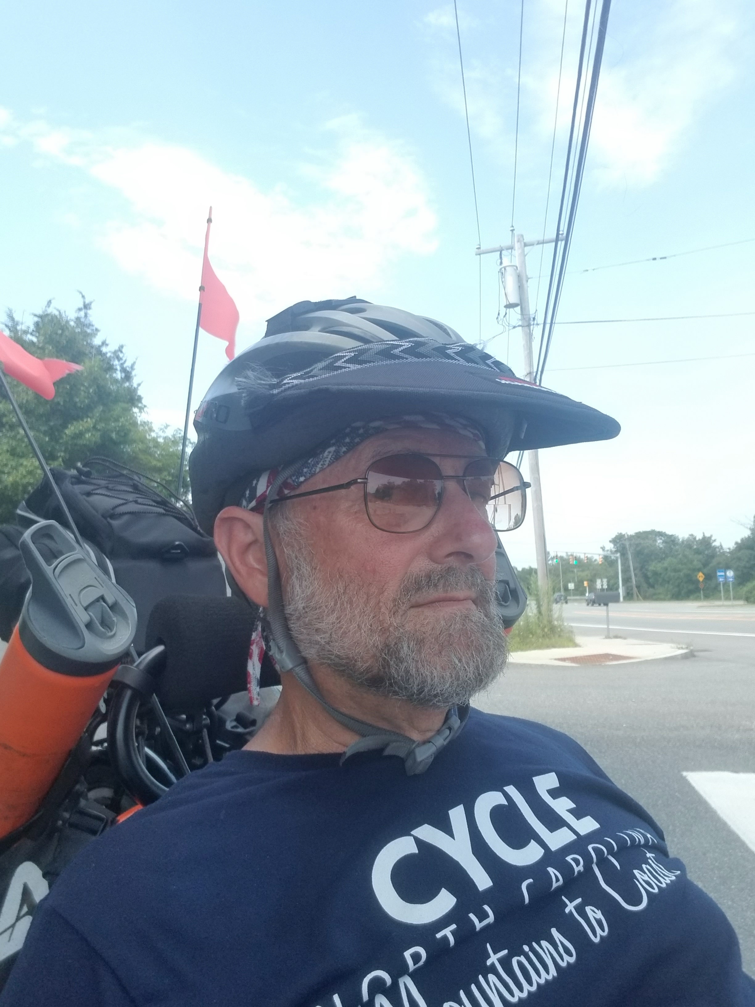 Cyclist wearing helmet and backpack outdoors