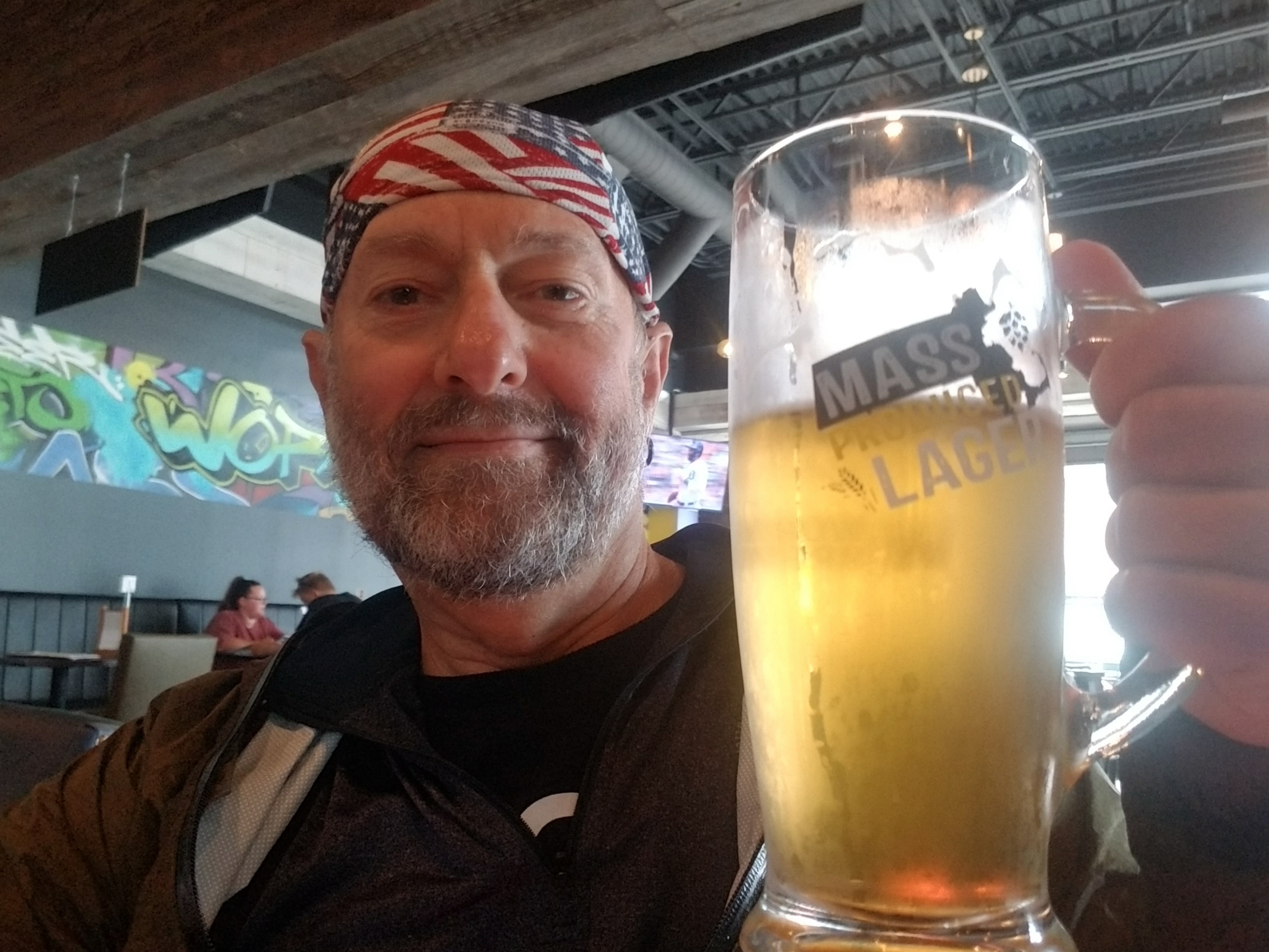Man holding large beer glass indoors