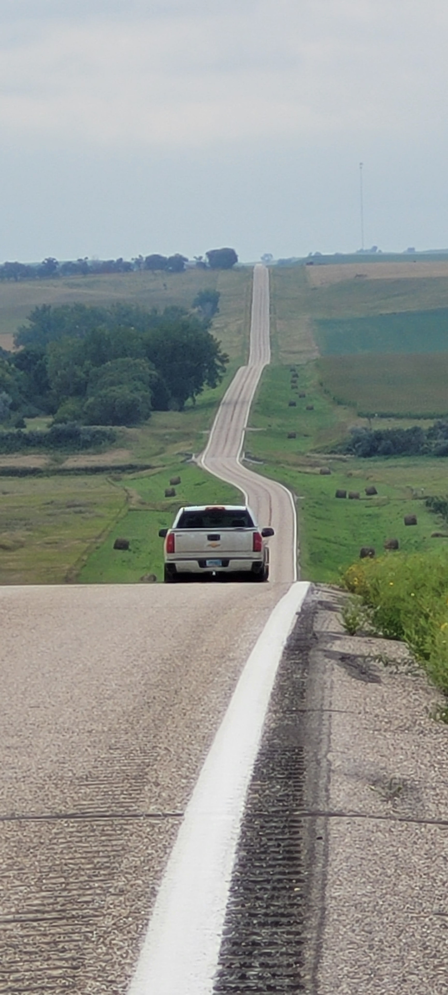 Truck driving straight rural highway landscape